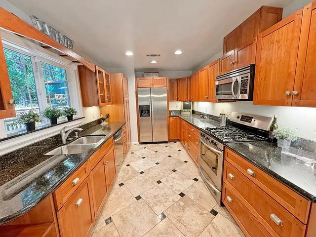 a kitchen with stainless steel appliances a stove sink and cabinets