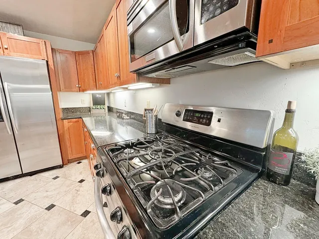 a kitchen with a stove and a refrigerator