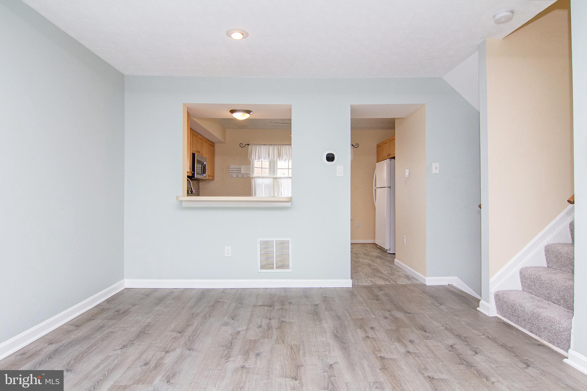840 Century Street Hampstead, MD 21074 - Photo 11 of 34 an empty room with wooden floor and windows