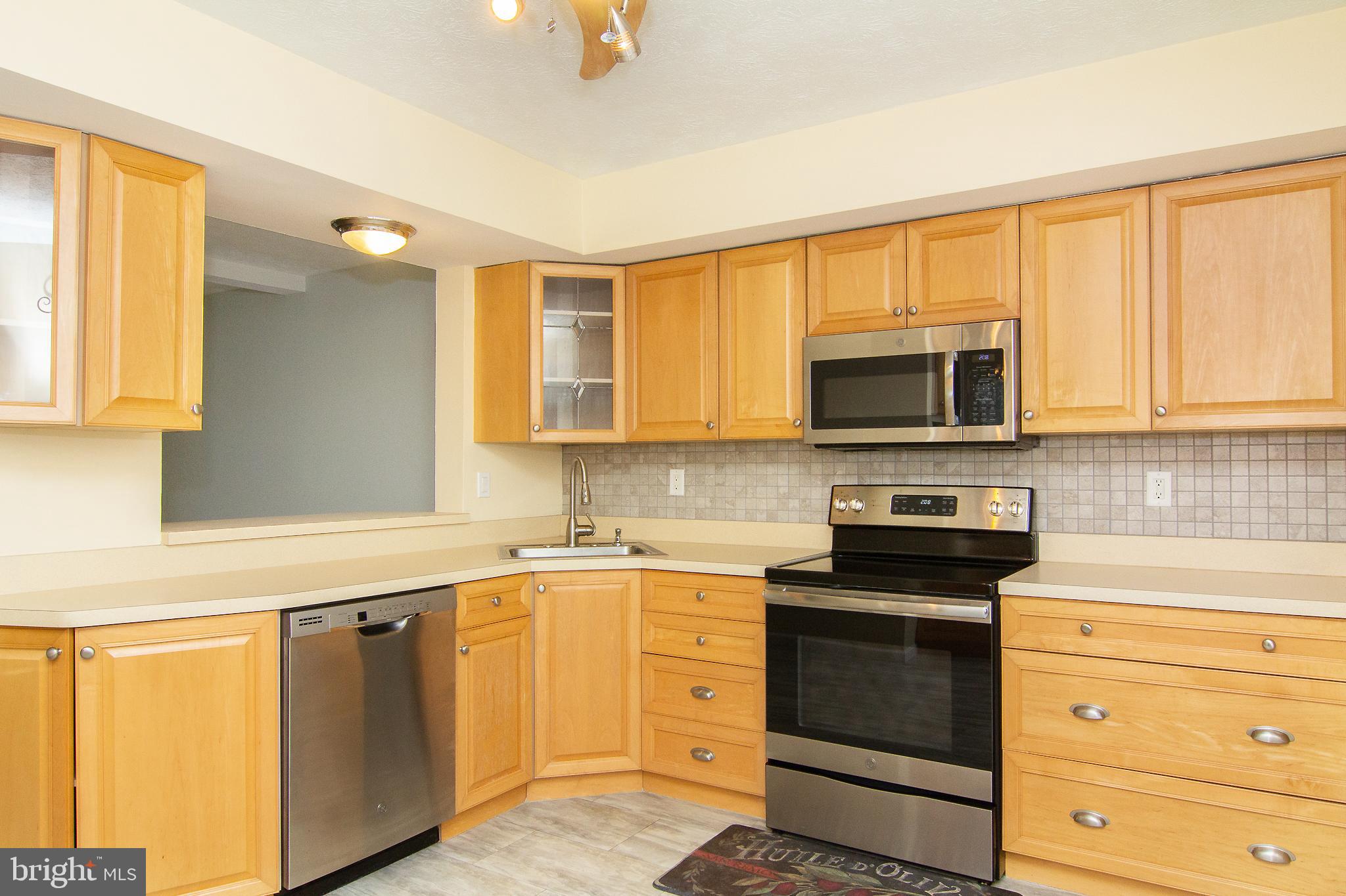 840 Century Street Hampstead, MD 21074 - Photo 13 of 34 a kitchen with a sink stove top oven and cabinets