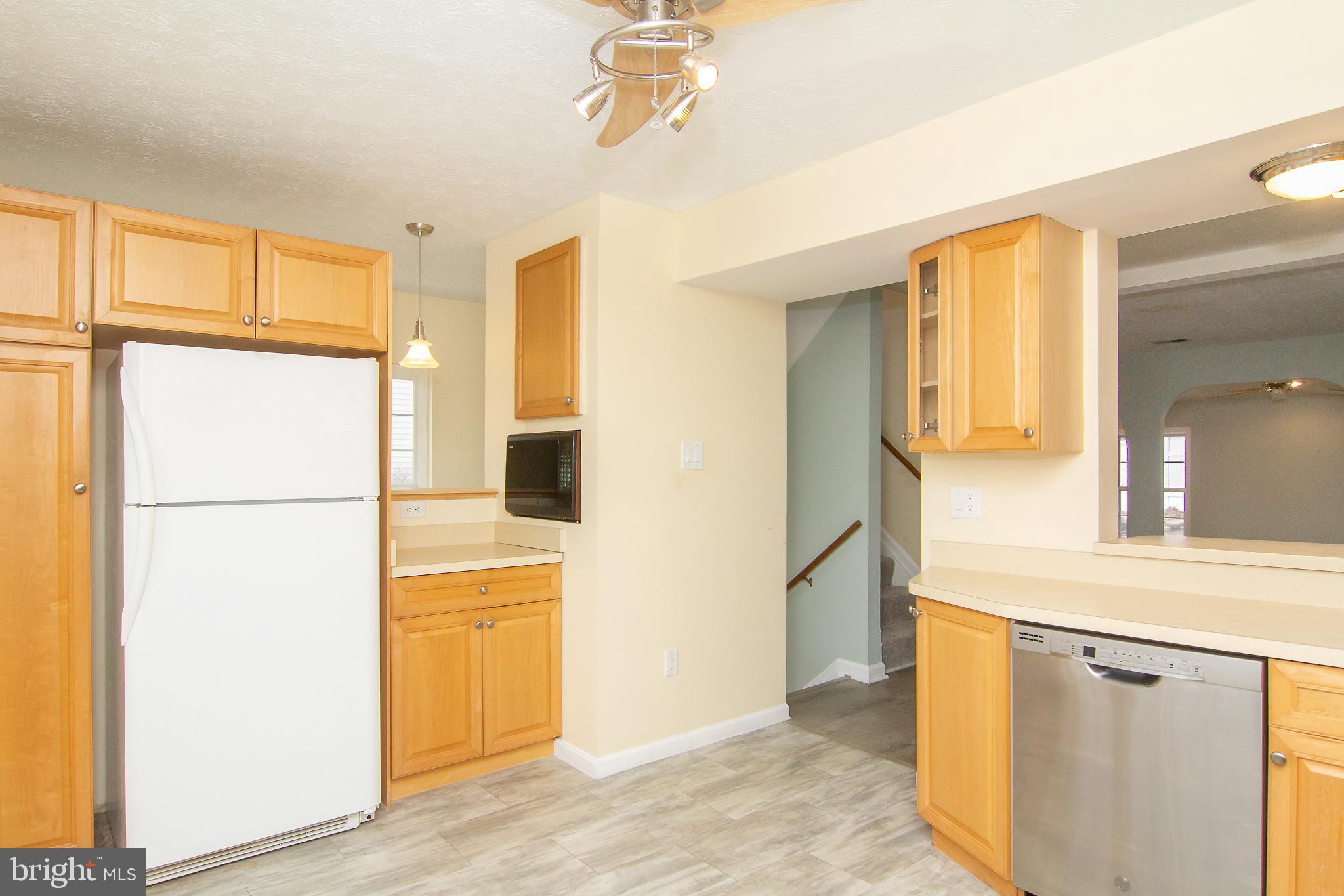 840 Century Street Hampstead, MD 21074 - Photo 14 of 34 a view of a hallway with a white cabinet and a refrigerator