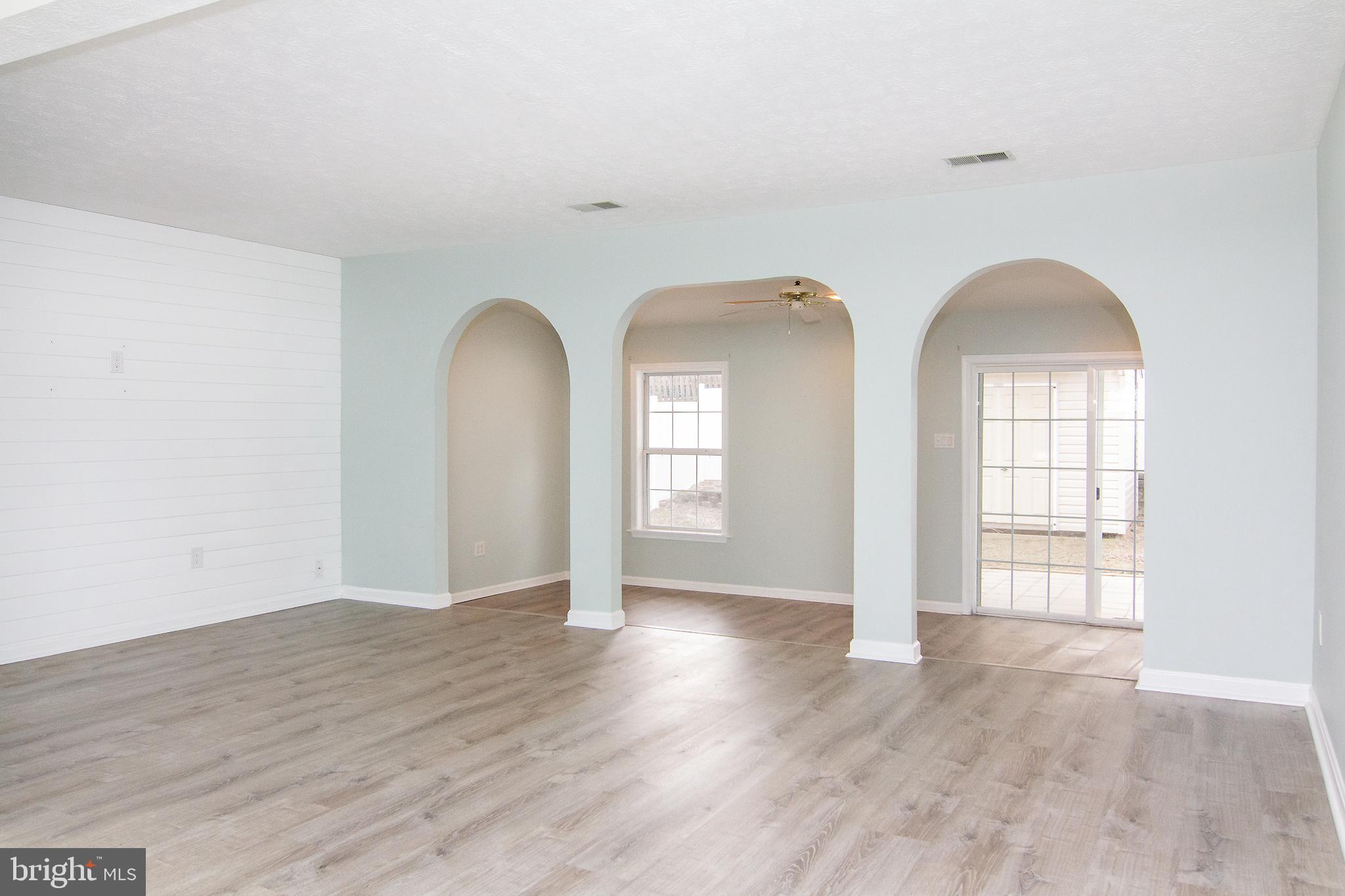 840 Century Street Hampstead, MD 21074 - Photo 7 of 34 an empty room with wooden floor and windows
