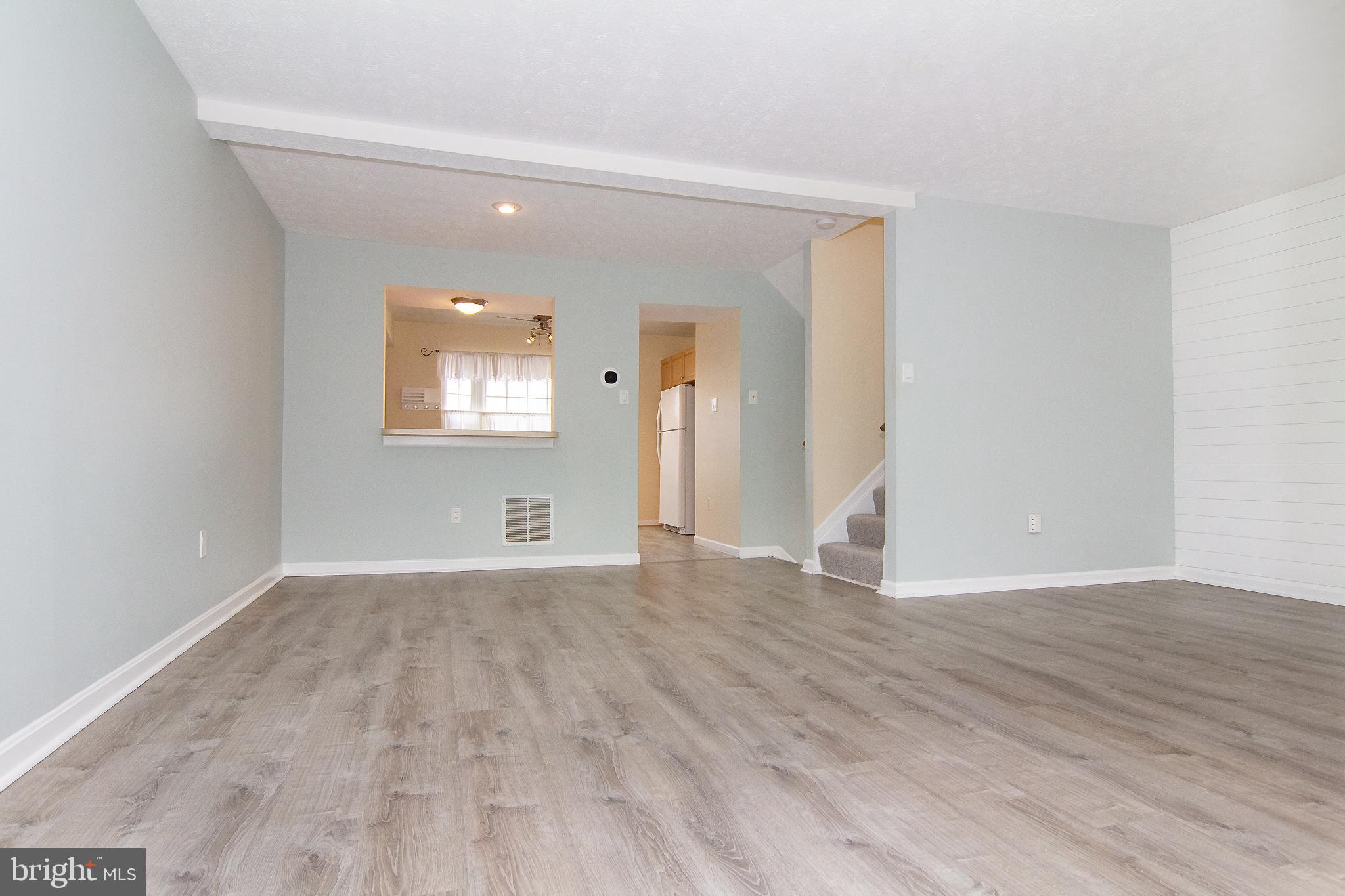840 Century Street Hampstead, MD 21074 - Photo 10 of 34 a view of an empty room with wooden floor and a window