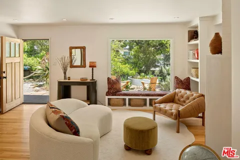 a view of a dining room with furniture and a window