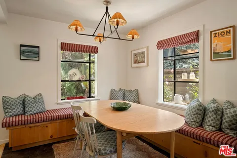 a kitchen with kitchen island granite countertop a sink and a stove