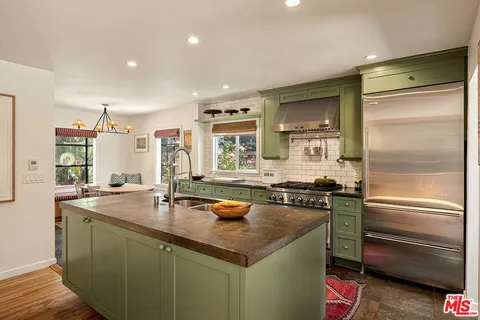 a kitchen with a table and chairs in it
