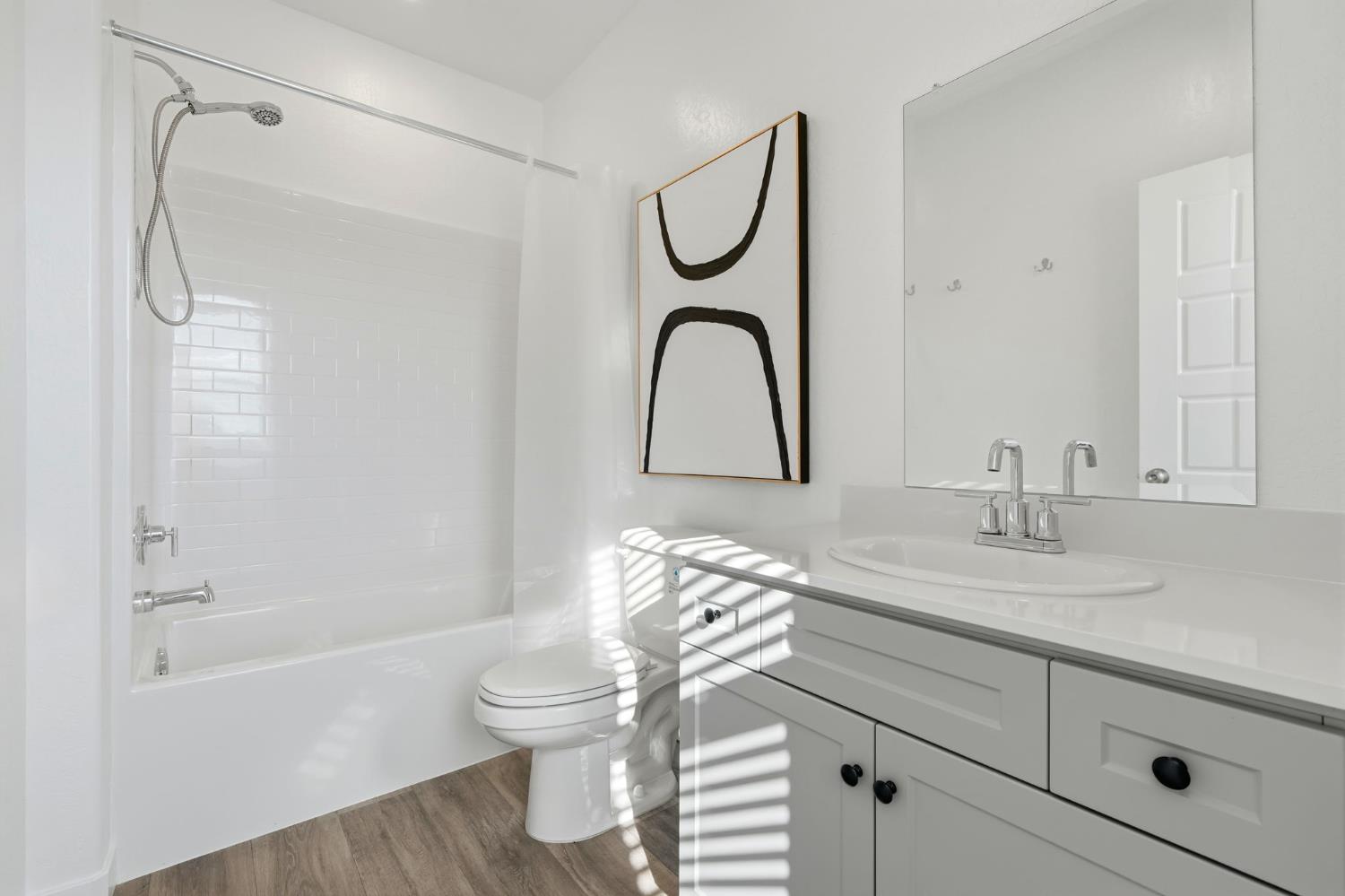 4225 Hampton Way Clovis, CA 93619 - Photo 27 of 37 a bathroom with a granite countertop sink a toilet and a bathtub