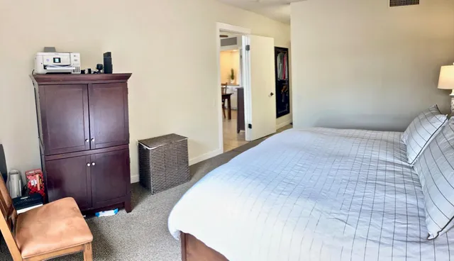 a bedroom with a bed and dresser