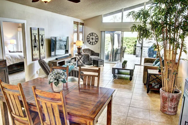 a living room with fireplace furniture and a large window