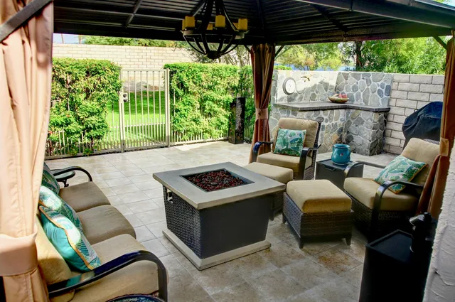 a dining room with furniture and a floor to ceiling window