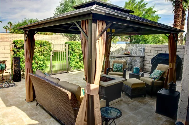 a view of a house with a yard and potted plants