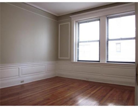 466 Commonwealth Avenue, Unit 506 Boston, MA 02215 - Photo 3 of 10 a view of an empty room with wooden floor and a window