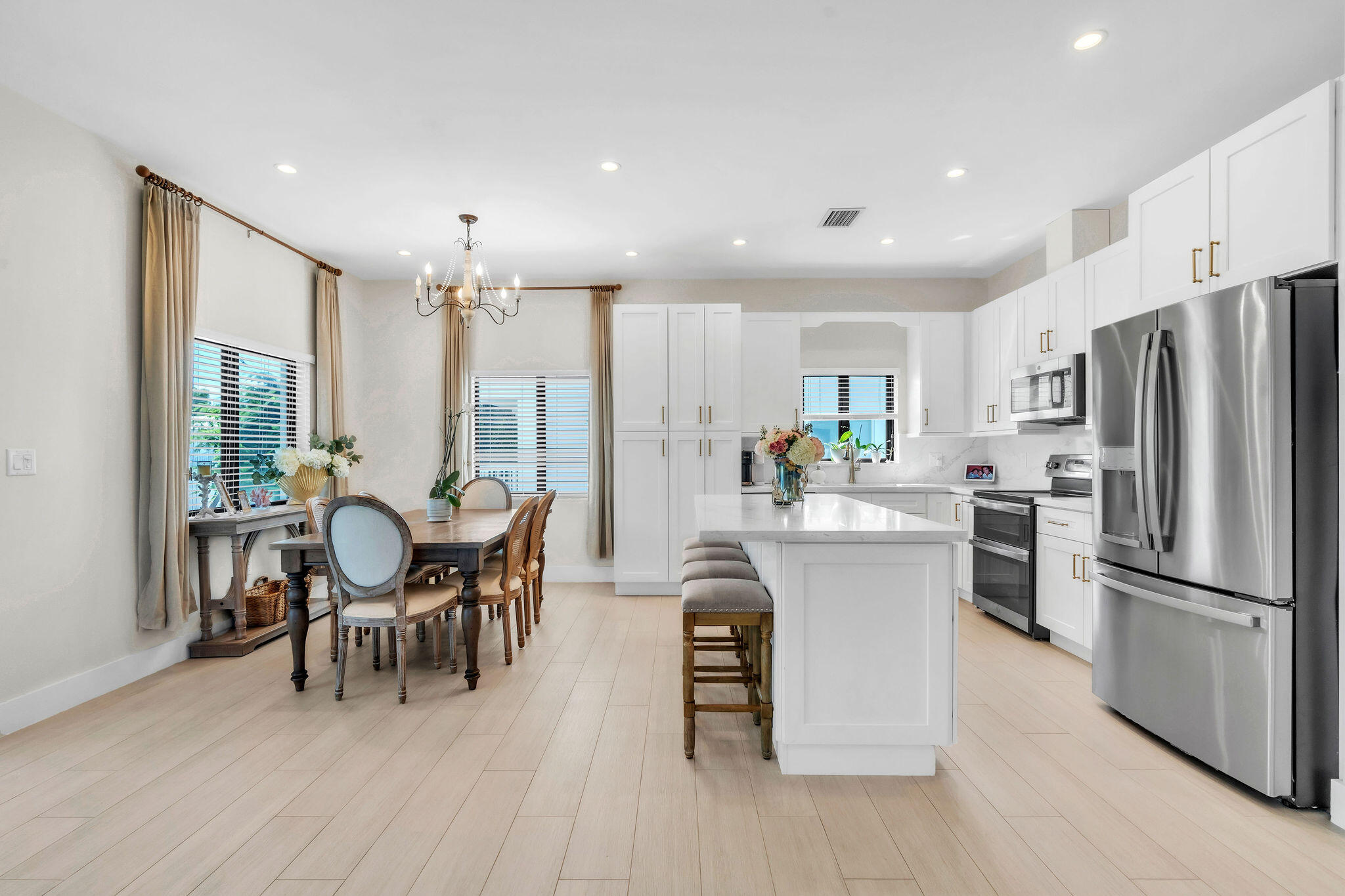 247 Hispanola Road Tavernier, FL 33070 - Photo 11 of 39 a kitchen with kitchen island wooden floor dining table and stainless steel appliances