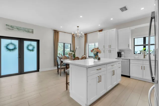 a kitchen with sink stove and cabinets
