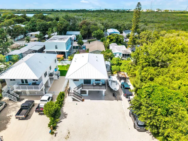 an aerial view of a house with lots of trees