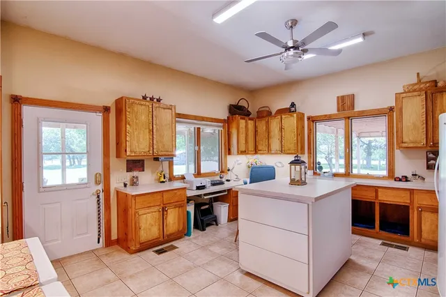 a view of a kitchen sink and microwave