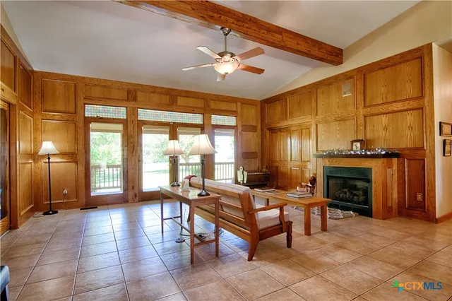 a living room with furniture a dining table and a fireplace