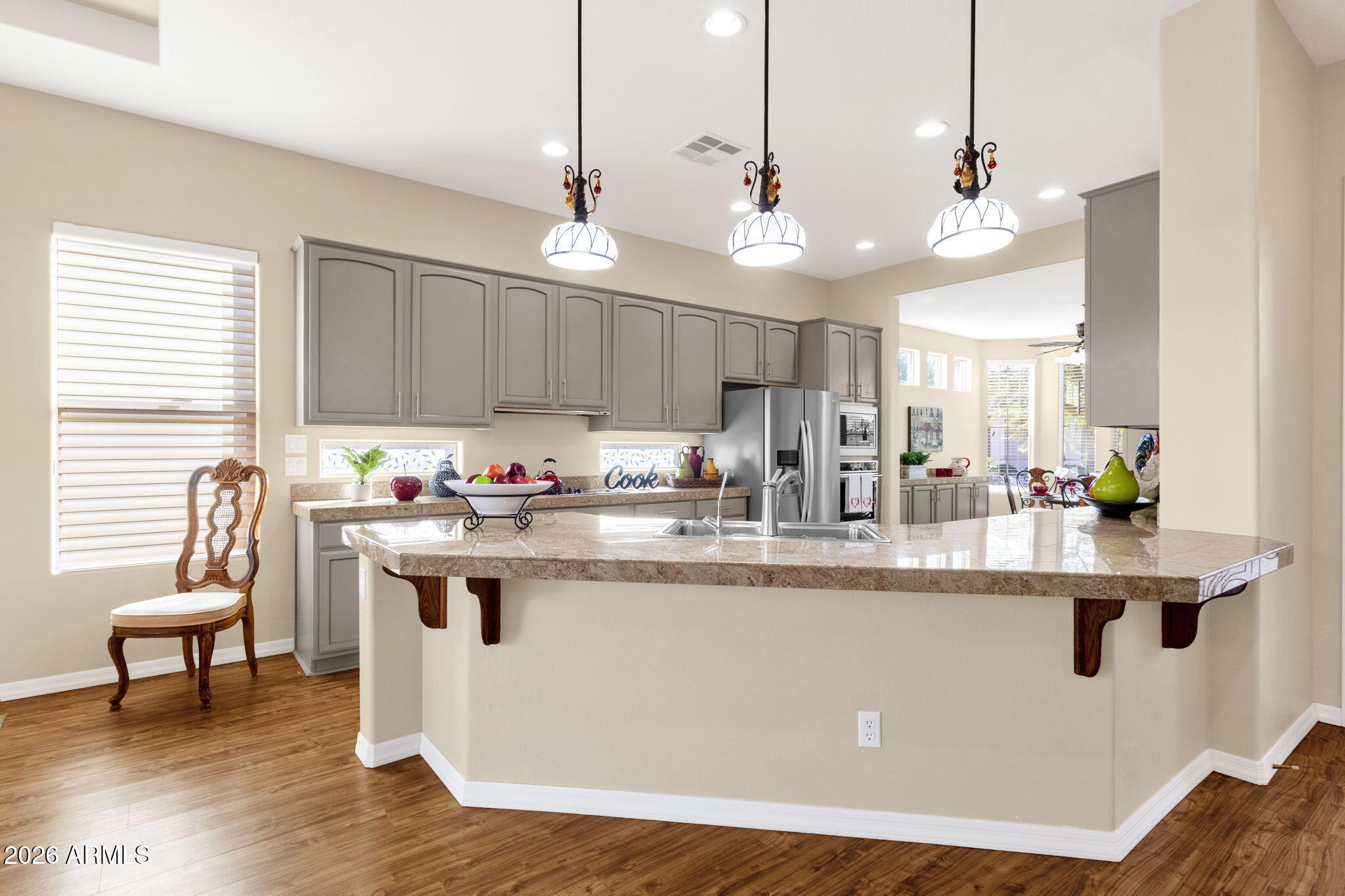 4734 East Indigo Street Gilbert, AZ 85298 - Photo 13 of 32 a kitchen with stainless steel appliances granite countertop a sink a stove and a refrigerator