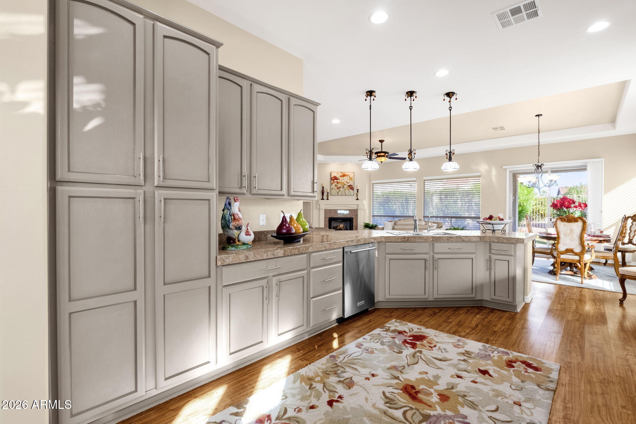 4734 East Indigo Street Gilbert, AZ 85298 - Photo 15 of 32 a kitchen with kitchen island granite countertop lots of counter top space and refrigerator