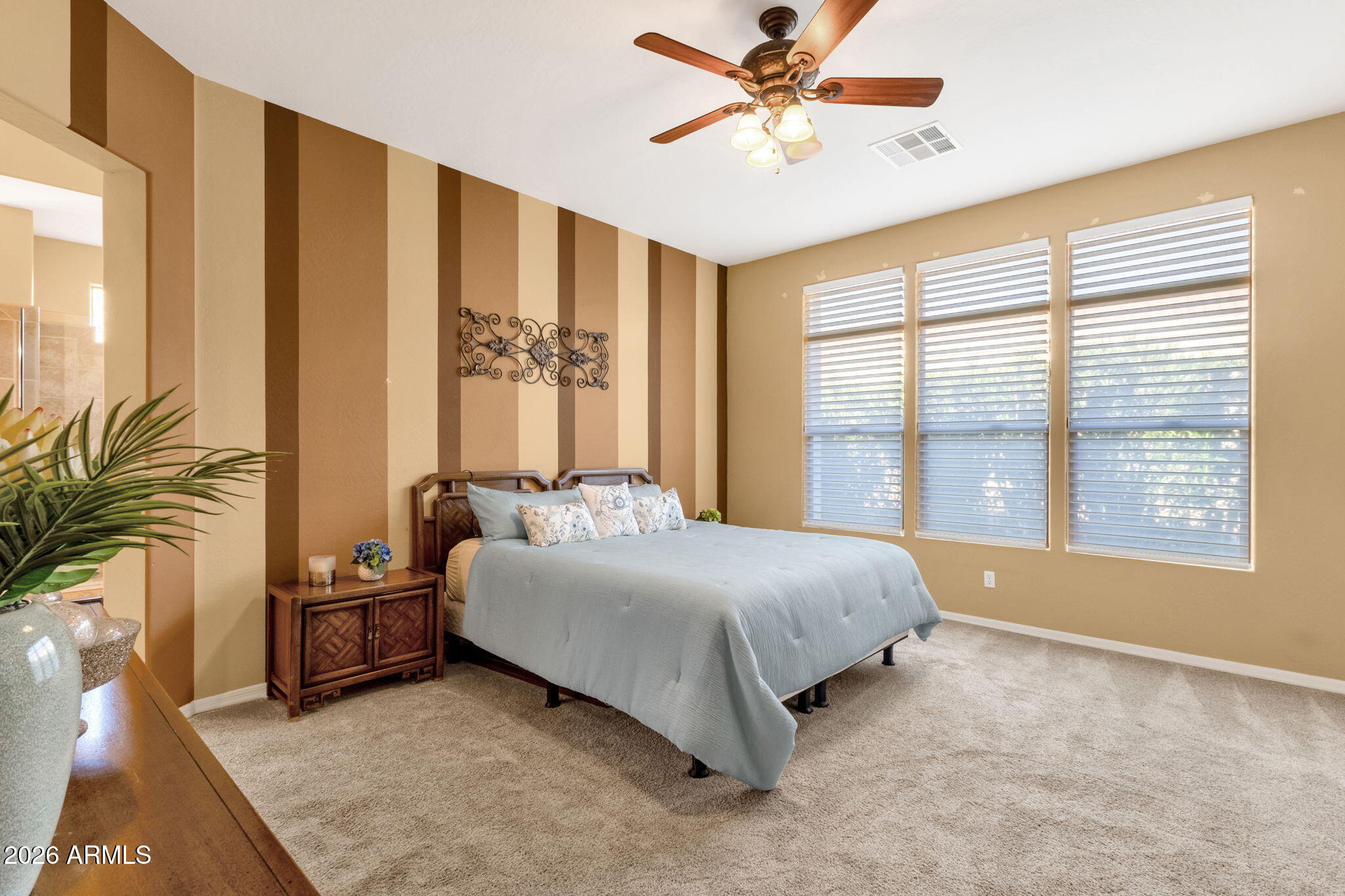 4734 East Indigo Street Gilbert, AZ 85298 - Photo 19 of 32 a spacious bedroom with a large bed and a chandelier