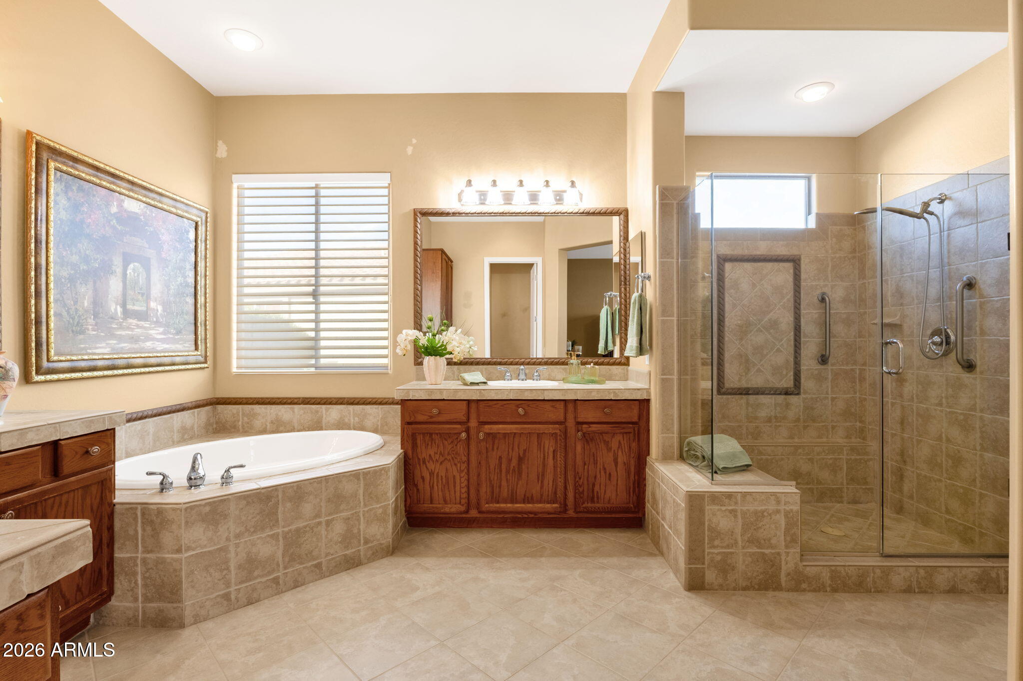 4734 East Indigo Street Gilbert, AZ 85298 - Photo 22 of 32 a bathroom with a tub a sink and mirror