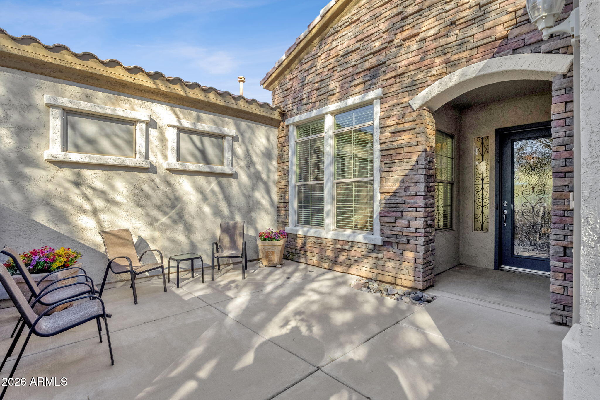 4734 East Indigo Street Gilbert, AZ 85298 - Photo 4 of 32 a view of a chairs with a table and chair in the patio