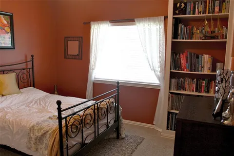 a bedroom with furniture and a book shelf