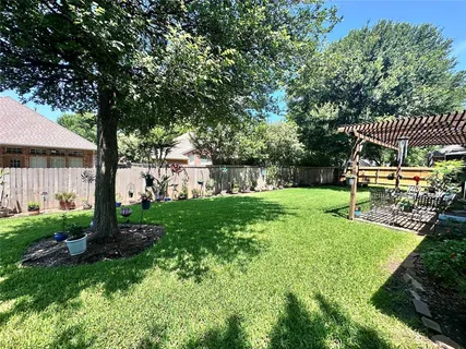 a view of a house with backyard and a patio