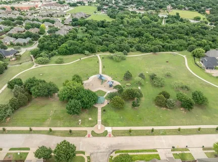 an aerial view of a residential houses with outdoor space and street view