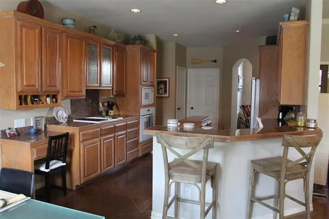 a large kitchen with kitchen island granite countertop a large island in the center