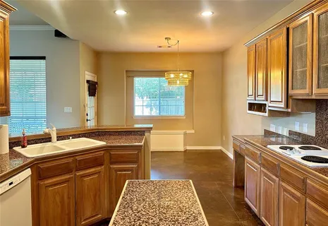 a kitchen with a sink stove and cabinets