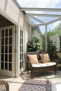a view of swimming pool with seating space and plants