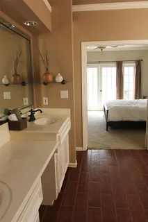 a bathroom with a sink a mirror and a bathtub