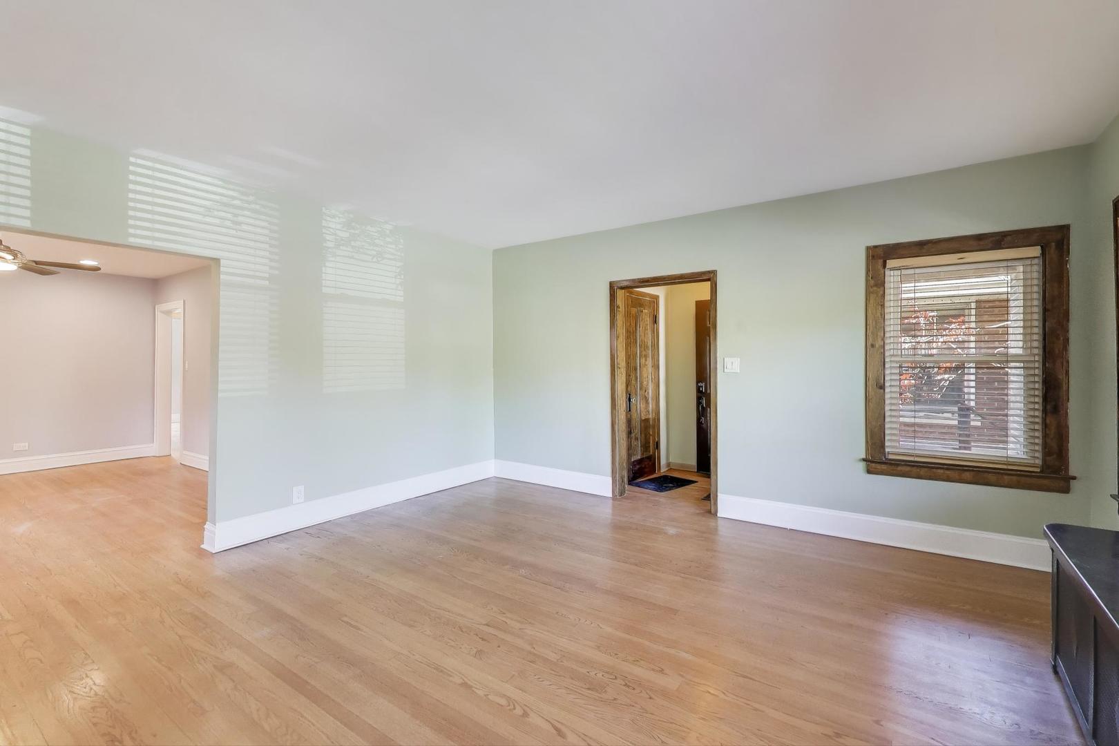 1020 Harvard Terrace Evanston, IL 60202 - Photo 6 of 31 a view of an empty room with wooden floor and a window