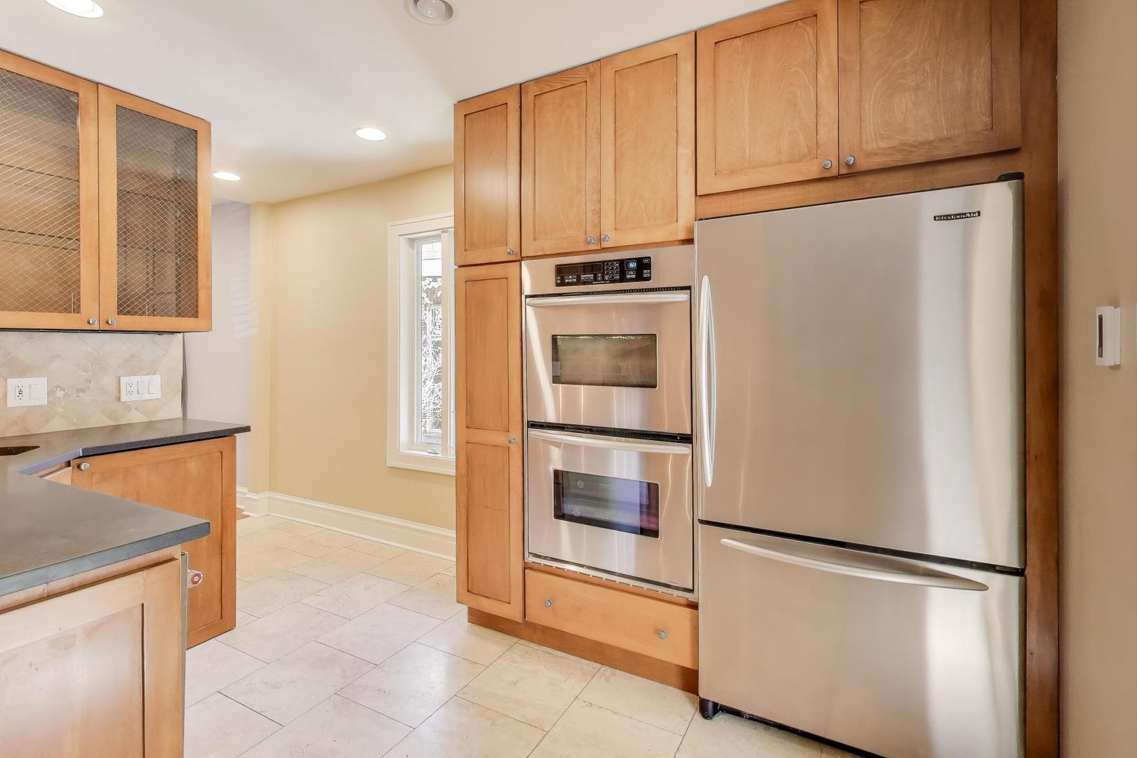 1020 Harvard Terrace Evanston, IL 60202 - Photo 10 of 31 a white refrigerator freezer and a stove sitting inside of a kitchen