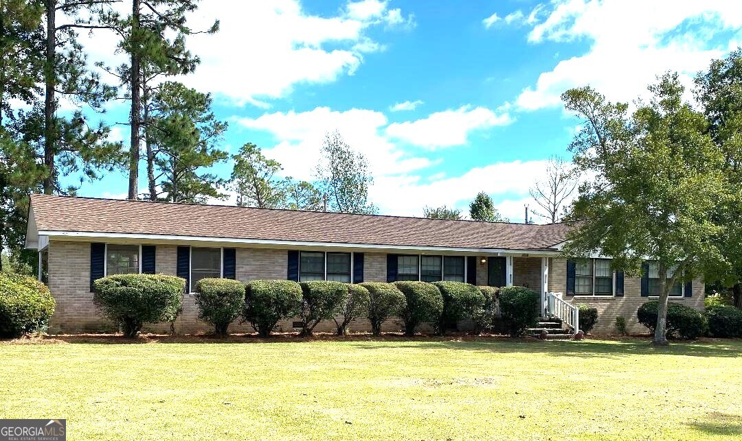 a view of house with swimming pool outdoor seating and yard