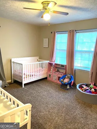 a bedroom with furniture and a window