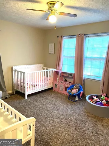 a bedroom with furniture and a window