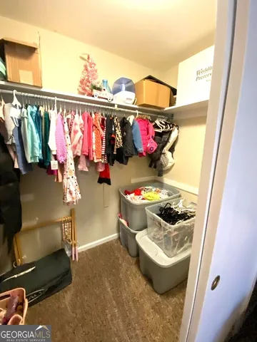 a storage room with water heater and racks