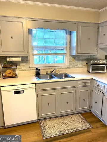 a kitchen with stainless steel appliances granite countertop a sink and cabinets