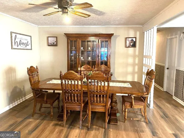 a view of a dining room with furniture wooden floor and chandelier
