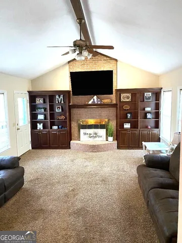 a living room with furniture and a flat screen tv