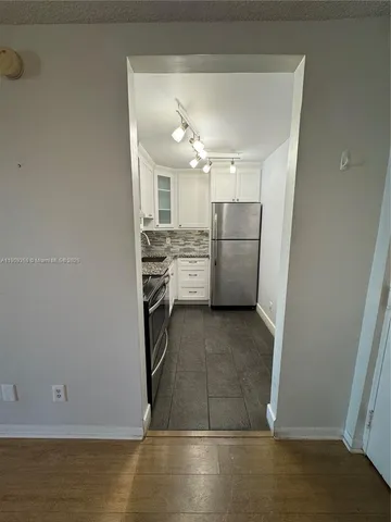 a kitchen with a sink and refrigerator