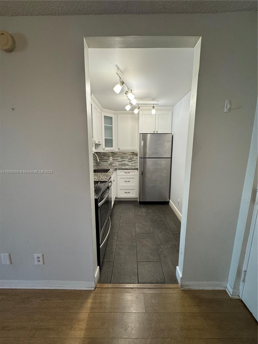 8411 Northwest 8th Street, Unit 203 Miami, FL 33126 - Photo 5 of 11 a kitchen with a sink and refrigerator