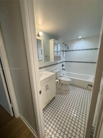 a bathroom with a sink a toilet a mirror and shower