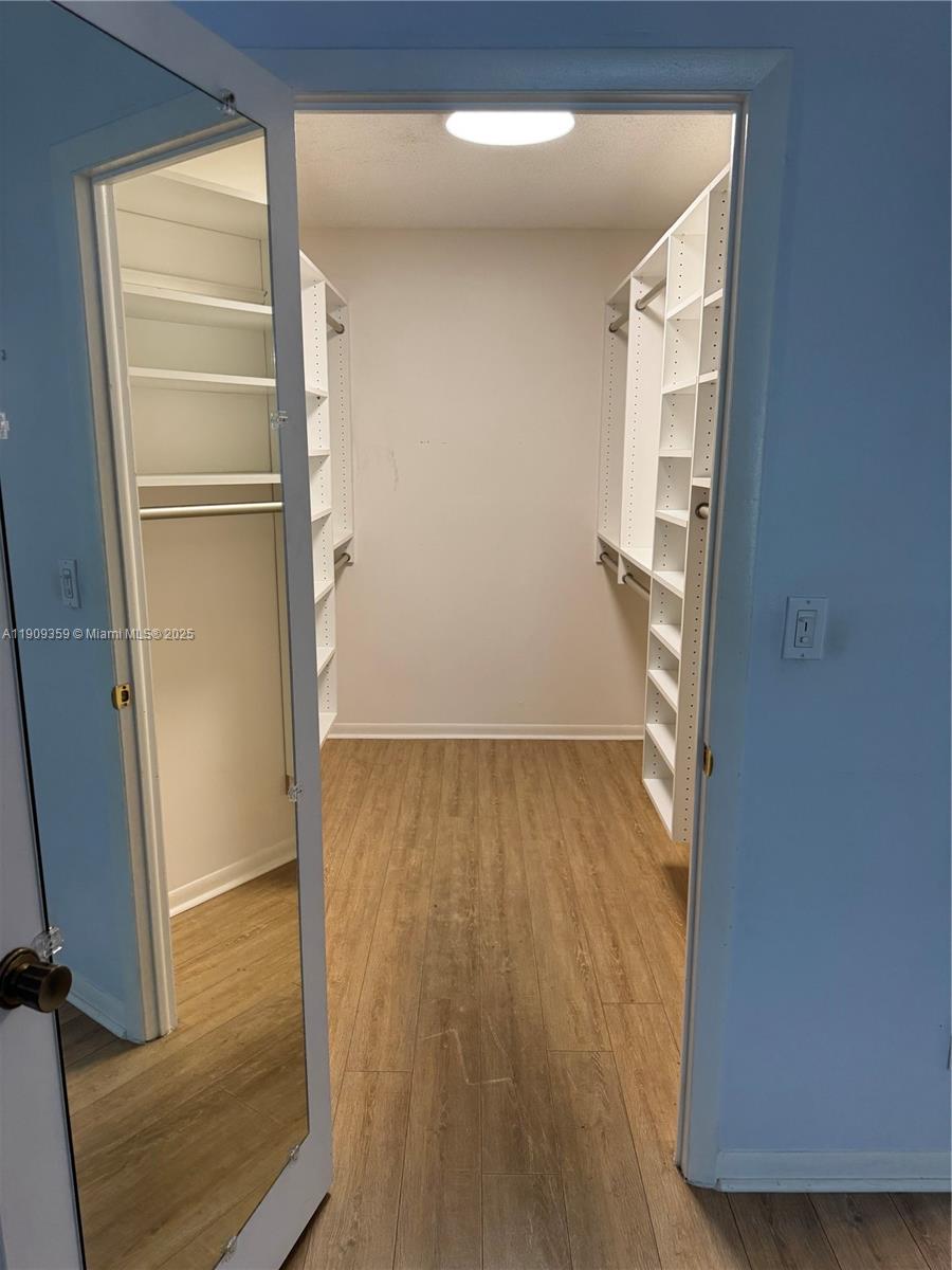 8411 Northwest 8th Street, Unit 203 Miami, FL 33126 - Photo 9 of 11 a view of empty room with wooden floor