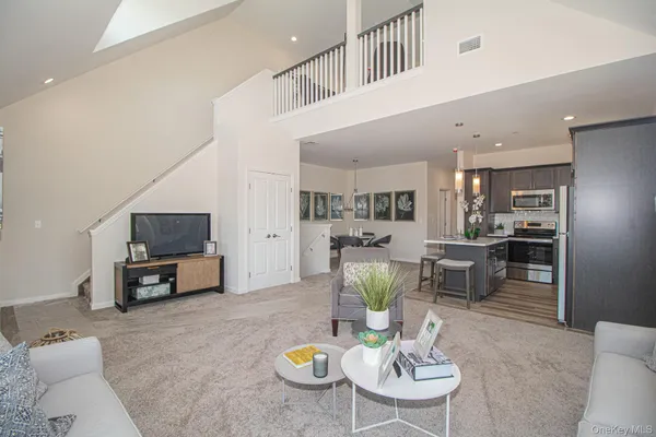 a living room with furniture and kitchen view