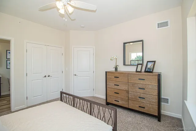 a bedroom with a bed and a dresser