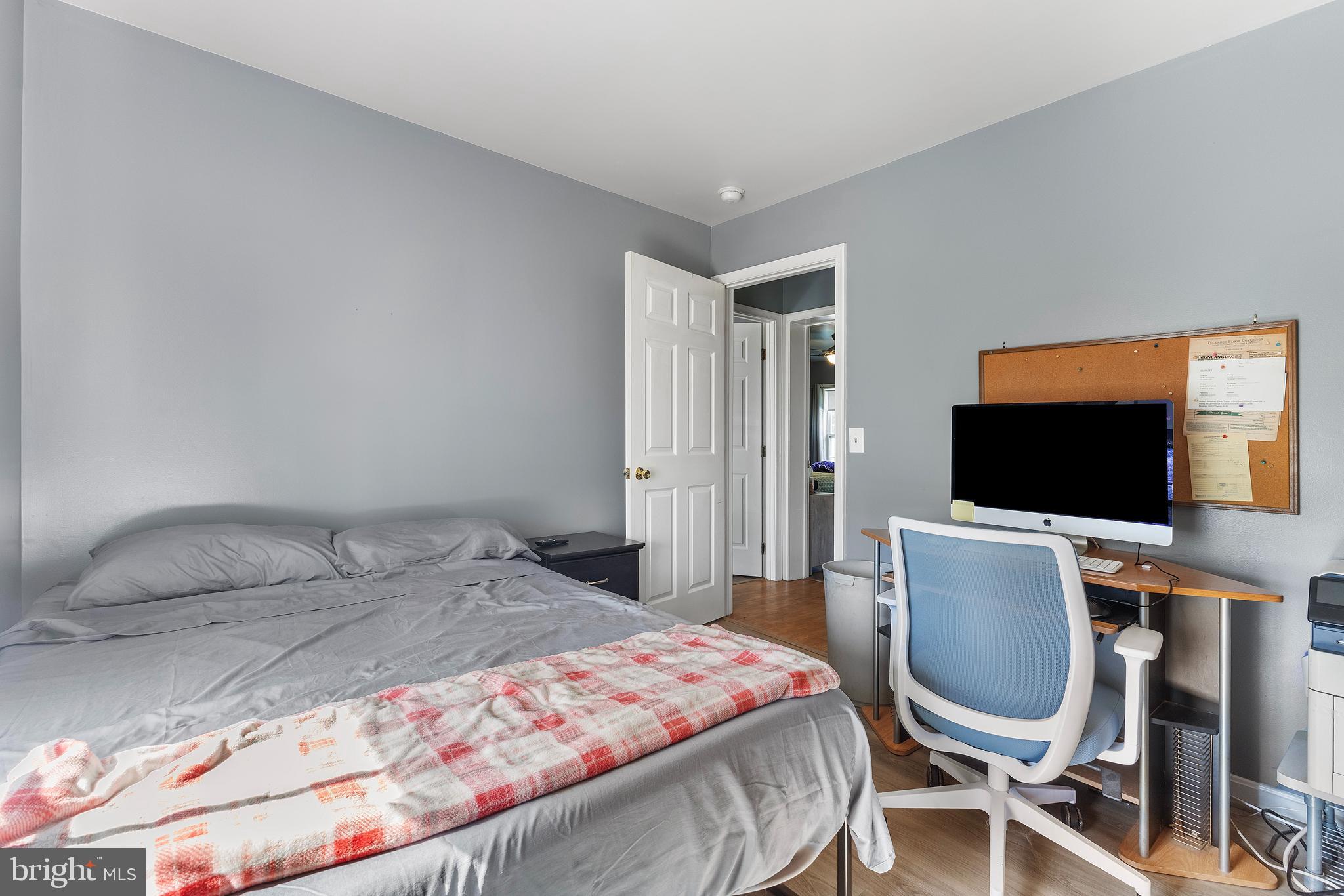 7112 East New Market Ellwood Road Hurlock, MD 21643 - Photo 13 of 41 a bedroom with a bed chair and a flat screen tv