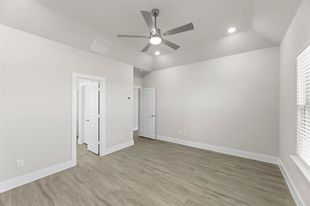 2372 Bell Way Forney, TX 75126 - Photo 15 of 39 an empty room with wooden floor fan and windows